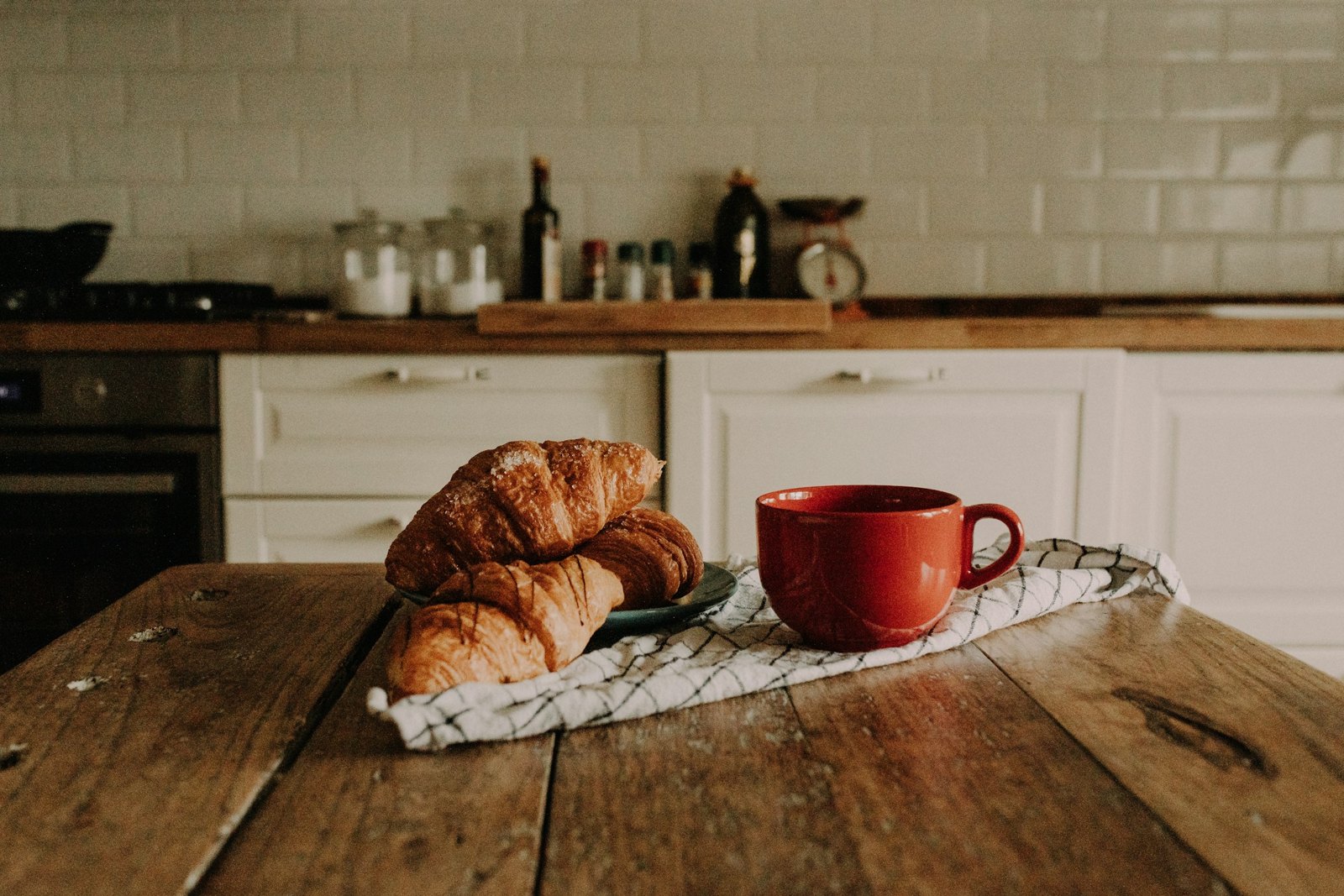 Fresh croissants and coffee on a rustic breakfast table